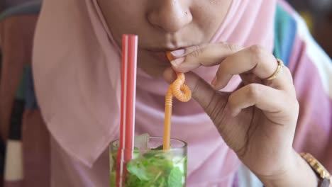 woman drinking a mojito