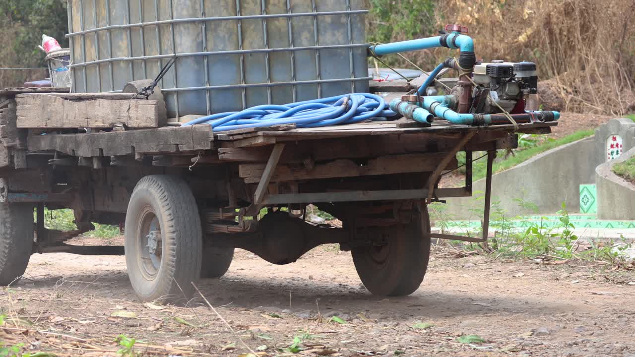 A trailer being loaded with large water tanks