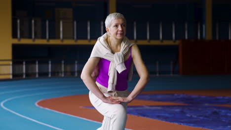 Senior-woman-stretching-indoors