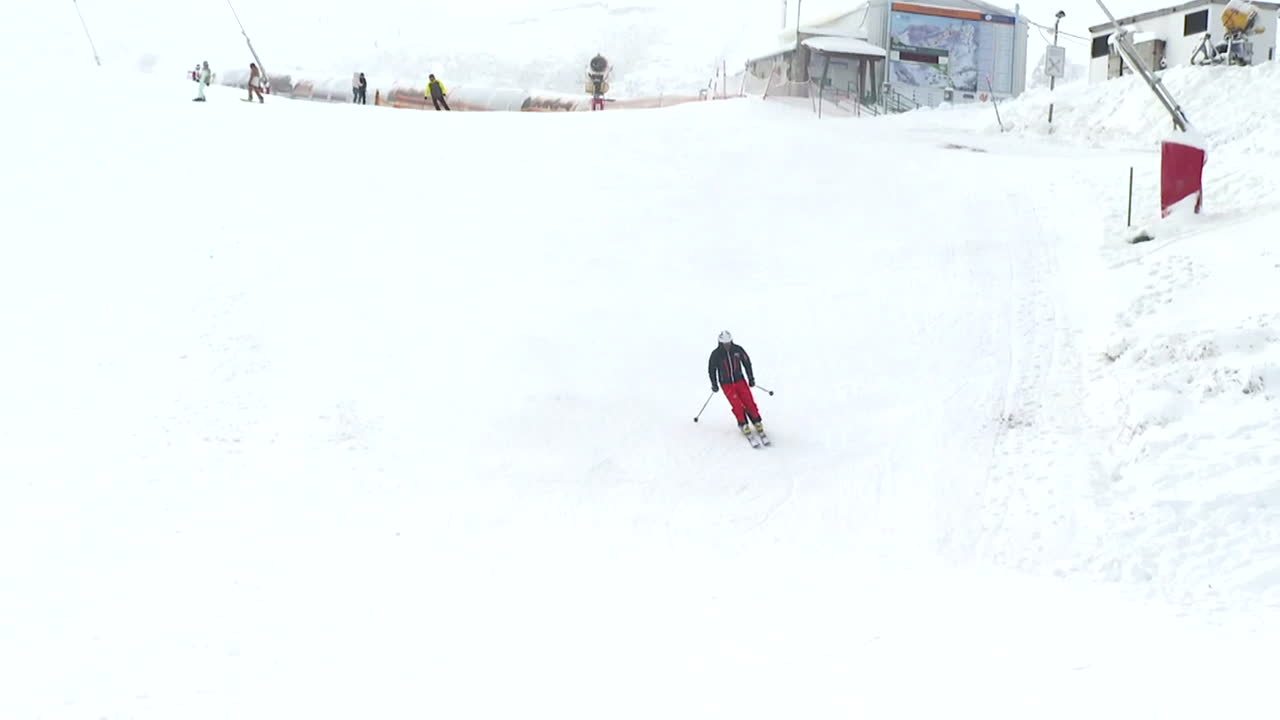 Skier on Snowy Mountain Slopes
