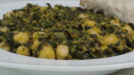 Tilt-Up-of-Chickpeas-with-Spinach,-Typical-Andalusian-Spanish-Dish