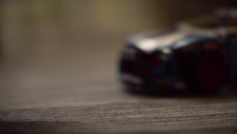 coins falling near toy car on mesh table