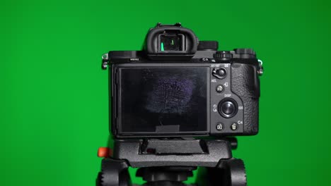 professional dslr photo camera with lens at green background. chroma key