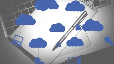 Animation-of-clouds-and-digital-icons-over-notebook-and-pen-on-desk