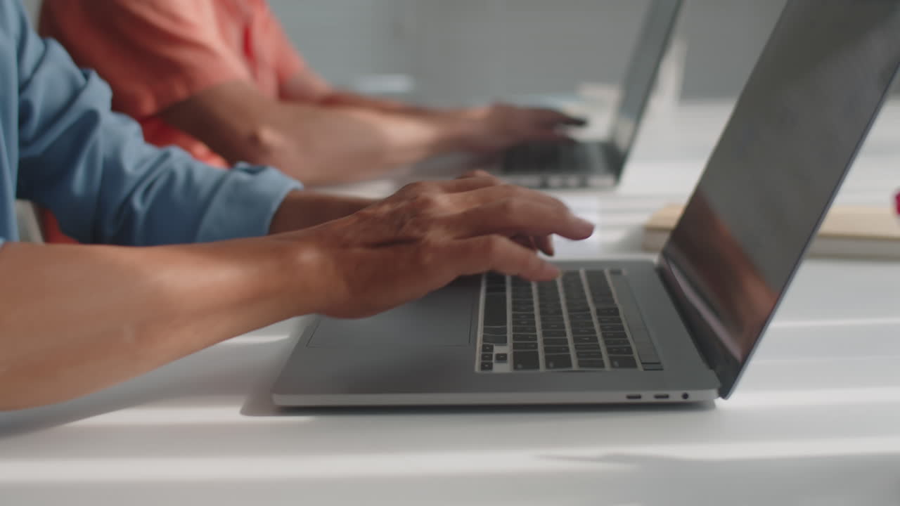 Hands of Retired People Typing on Laptops