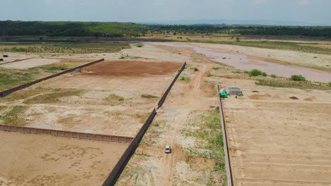 tomada aérea de drones de tierras agrícolas listas para la cosecha y el verde bosque tropical en la distancia en punjab