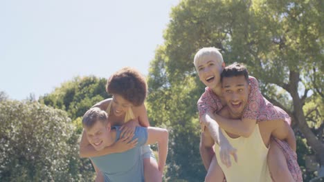 Portrait-of-happy-diverse-group-of-friends-playing-in-garden-in-summer