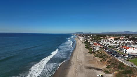 aerial backward movement shot over the beautiful beach of carlsbad california, usa