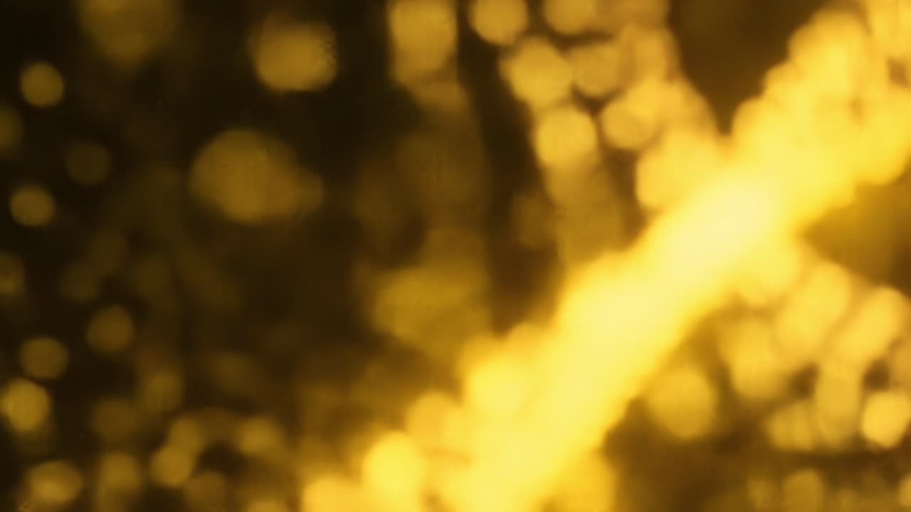 Warm golden light shimmering against the backdrop of a bustling city creates an enchanting mood. The play of light enhances the urban landscape with a dreamy texture blending warmth with modernity.