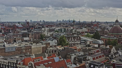 Amsterdam-Netherlands-Aerial-v25-cinematic-low-level-flyover-downtown-capturing-cityscape-of-grachtengordel-and-binnenstad-neighborhoods-with-traditional-dutch-style-architectures-facade---August-2021