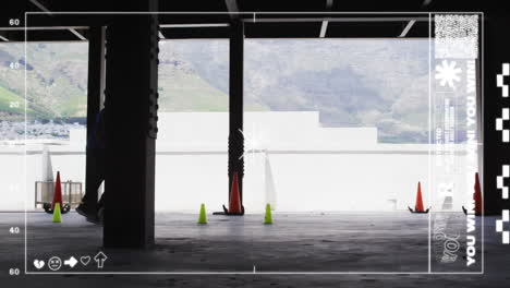 standing near pillars with traffic cones, person using social media interface