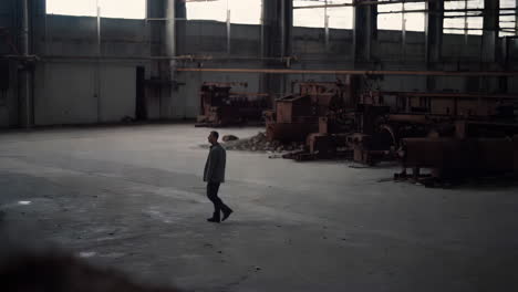 man walking in an abandoned factory