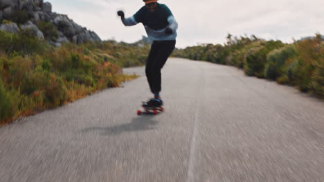 young friends longboarding together enjoying relaxed summer vacation riding skateboard on road teenagers cruising in countryside wearing protective helmet