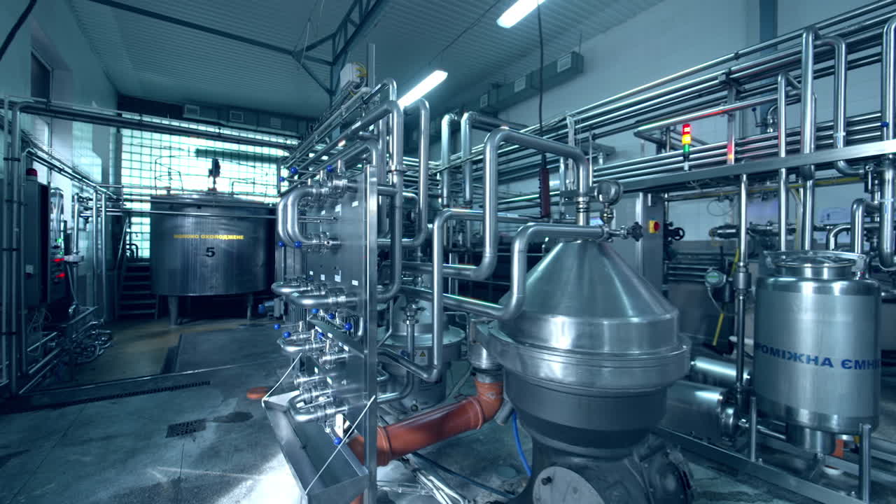 Dairy plant premise with fully automatic equipment. Stainless steel installation for the processing milk and producing dairy products.