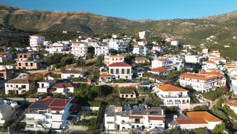Albanian-Riviera-Coastal-Town-of-Himare,-Albania---Aerial-Pullback-Reveal-Shot