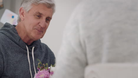 happy mature couple eating breakfast together husband having conversation with wife at table sharing morning meal in kitchen day in the life 4k footage