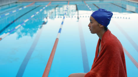 female swimmer sitting near swimming pool 4k