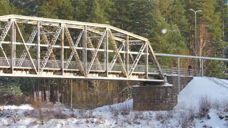 the old railway bridge over the river in winter