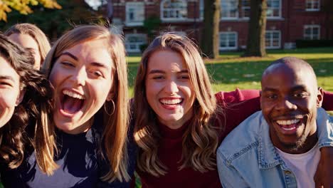 happy students taking a group selfie on campus