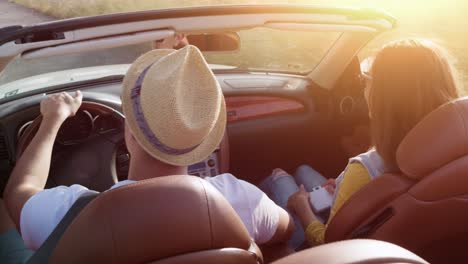 friends enjoying a summer road trip in a convertible