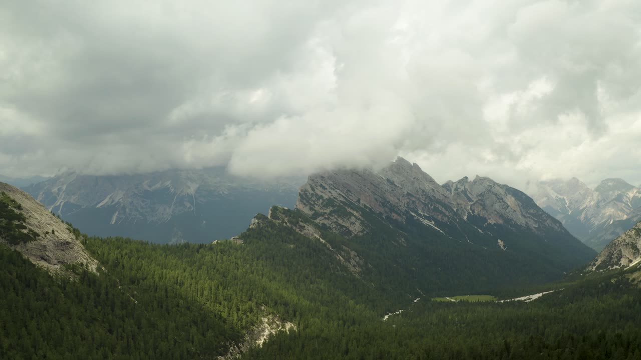 Rain clouds moving over beautiful mountain range in Dolomites, ITaly