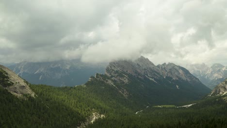 rain clouds moving over beautiful mountain range in dolomites, italy