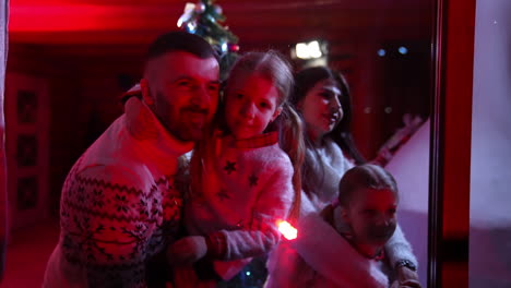 portrait of a family at christmas. festive atmosphere of a young family in the evening in cozy house. happy together on winter holidays.