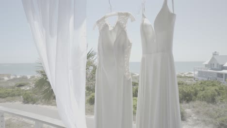 beautiful wedding dresses hanging ready for two brides