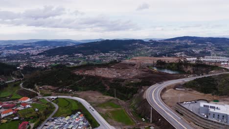 aerial - industrial site with curved road and wide valleys in revinhade felgueiras portugal