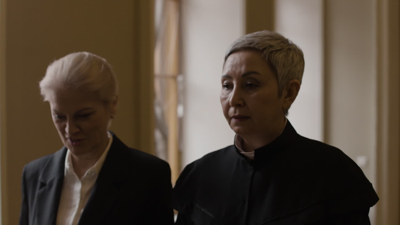 Two Women in Formal Attire in a Courtroom