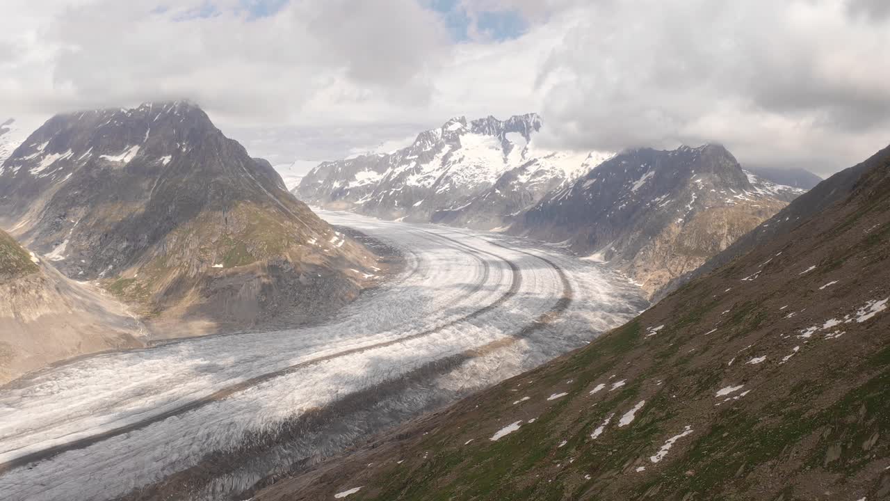 Glacier surrounded by mountains in Norway, showcasing rugged, snowy landscapes