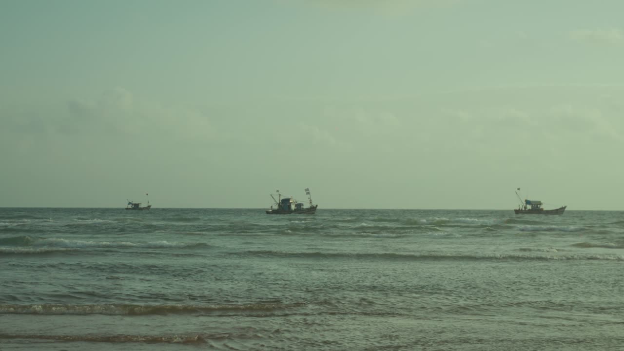 Fishing boats navigating the gentle ocean waves under an overcast sky, representing a tranquil marine life, traditional livelihoods, and the vast open sea
