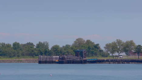 white prison bus entering dock at hart island nyc