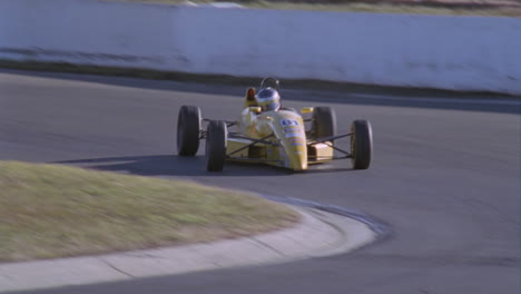 a formula car drives on a circuit track 12