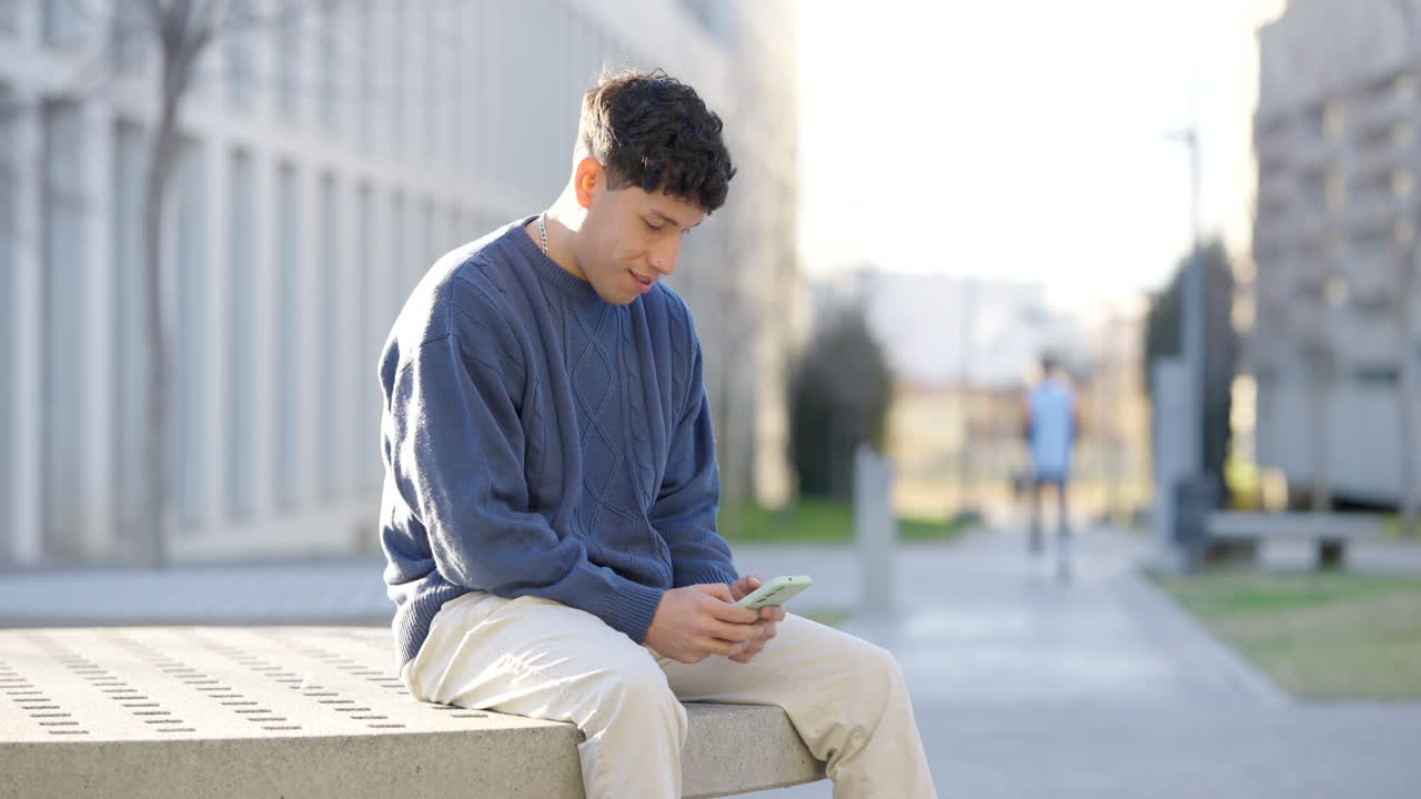 Young man using smartphone on city bench montage