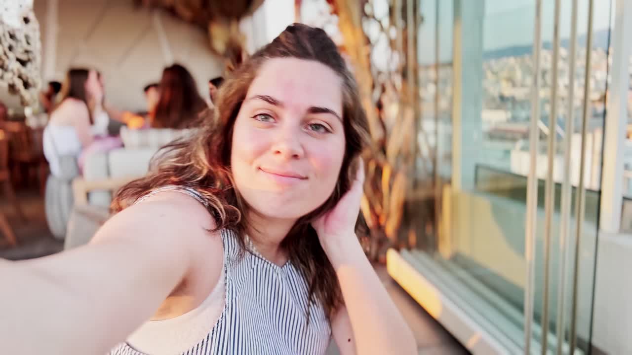 Smiling Woman Taking Selfies Outdoors During Golden Hour