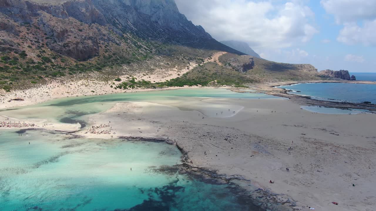 Balos Beach in Crete Greece with blue turquoise-colored water and rocky shore, Aerial flyover shot