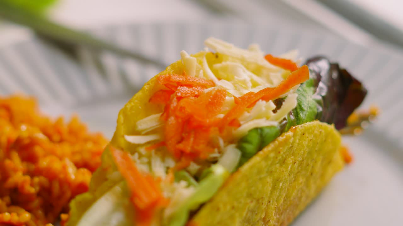 Delicious Fresh Mexican Tacos Made from Crispy Corn Tortilla Filled with Variety of Ingredients including Beef, Lettuce, Carrot, Tomatoes and Cheese. Fresh Food Originally from Mexico