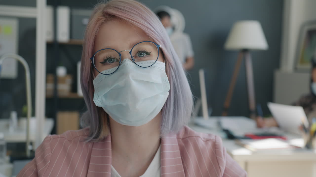 Woman in Office Wearing Mask and Glasses