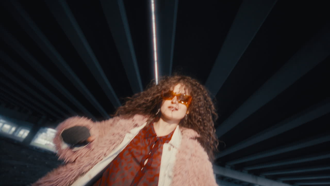 Stylish Girl Performing Dance on Camera under Urban Overpass