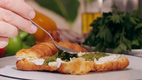 Croissant with jamon ham, Salmon, in Modern Cafe, Top View of Healthy Breakfast in Cafe. English breakfast: fried egg, bacon toast on sandwich.