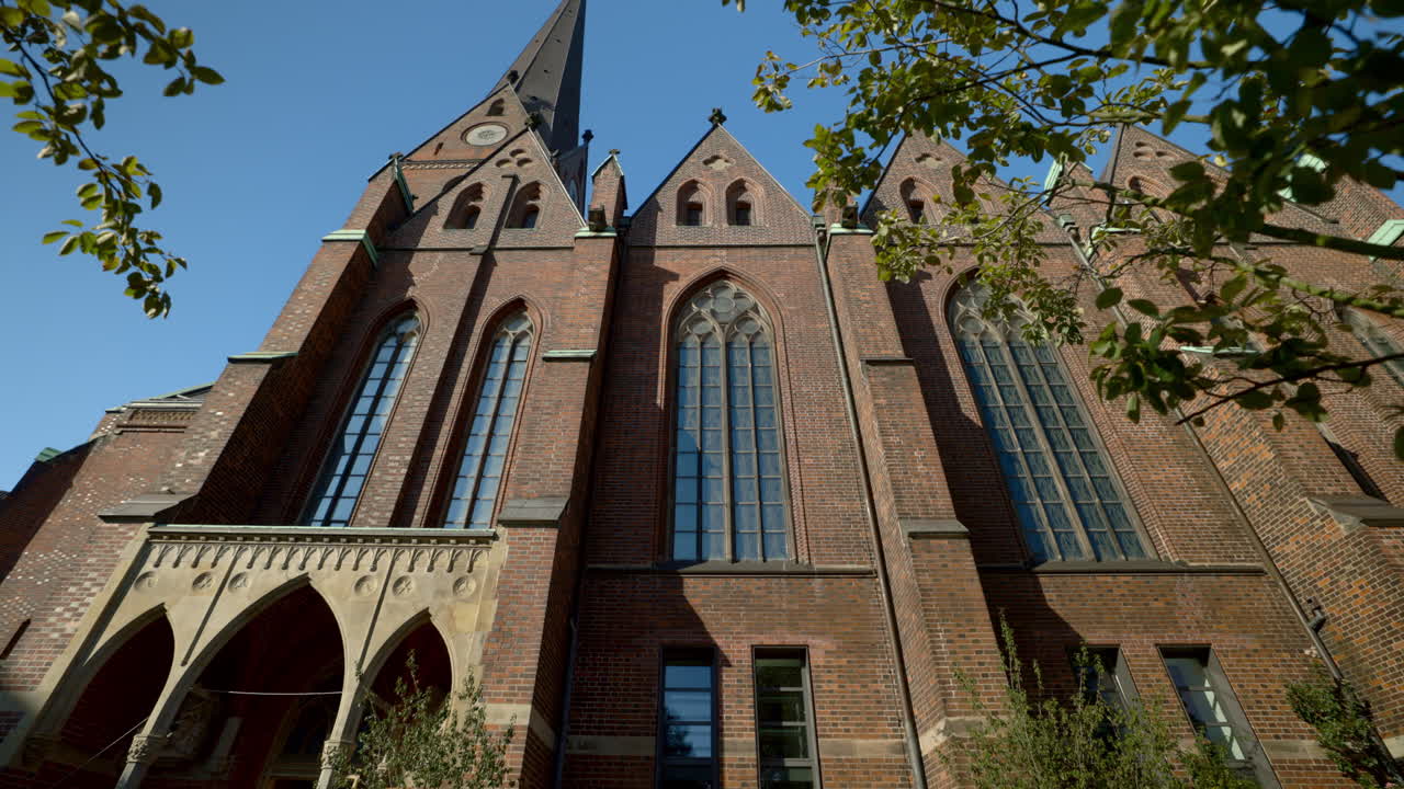 Exterior view of a brick church with a spire
