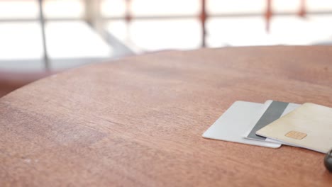 crumpled money and credit cards on a wooden table