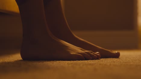 barefoot feet on carpet at night