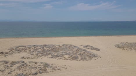 4k moving forward clip over a peninsula on the tropical beach of epanomi, halkidiki, greece