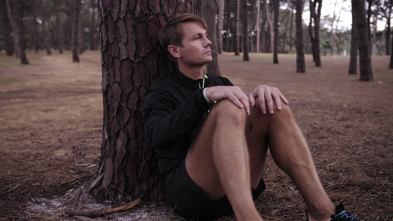 Depressed Man  with Pine Tree Forest Surrounding Him