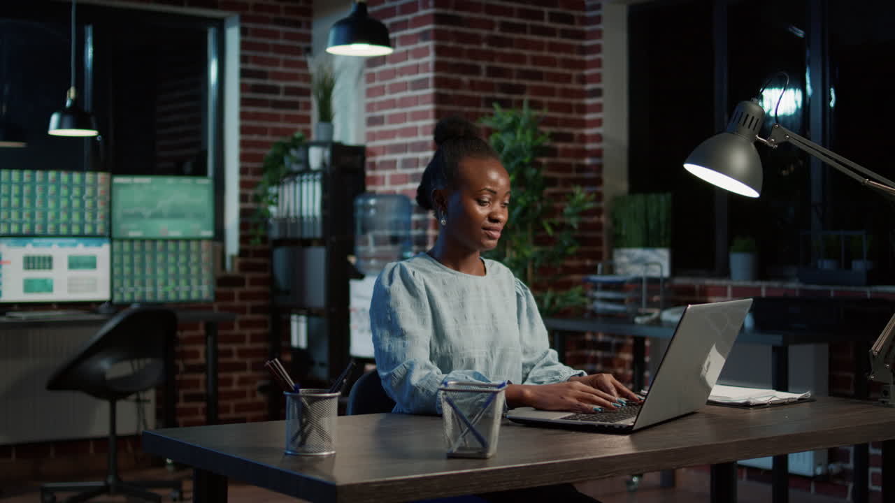 African american woman working on laptop to create stock sales