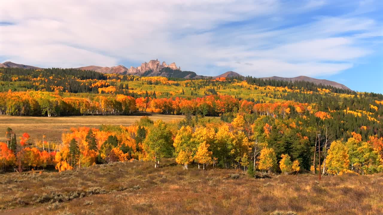 The Castle Mountain Mill Castle Gunnison National Forest Crested Butte Ohio Kebler Pass Colorado aerial drone parallax morning autumn fall Aspen tree colors blue sky clouds ranch farmland upwards