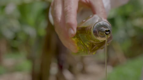 the chef pours extra virgin olive oil over the cooking dish from a bottle