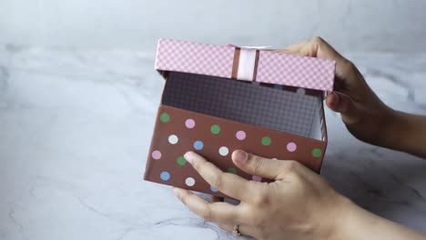 woman opening a gift box